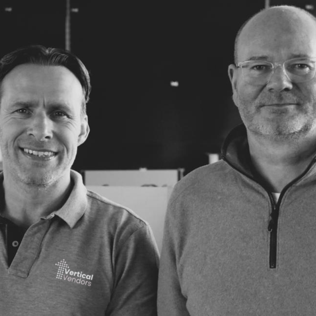 A black and white photo of co-founders Ben Jones-Fenleigh and James Cooper, smiling