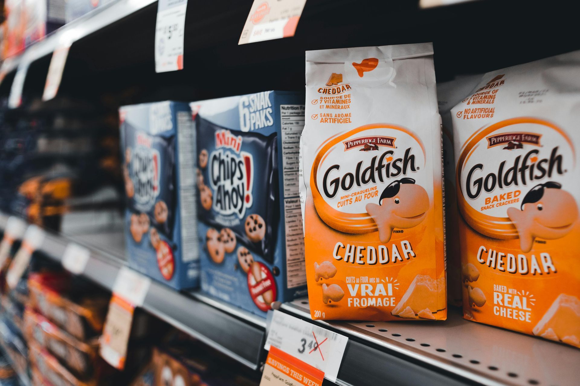 A high-end, sleek black metal spring-loaded display unit filled with premium beverage cans in a mode