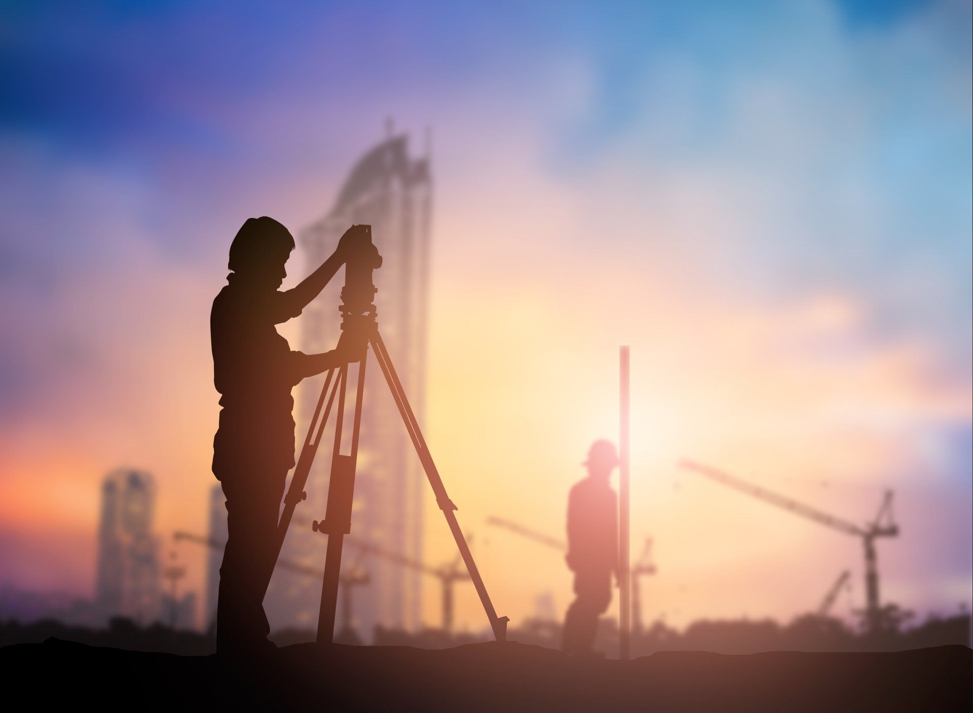 Man and Woman Using a Surveyor Tool