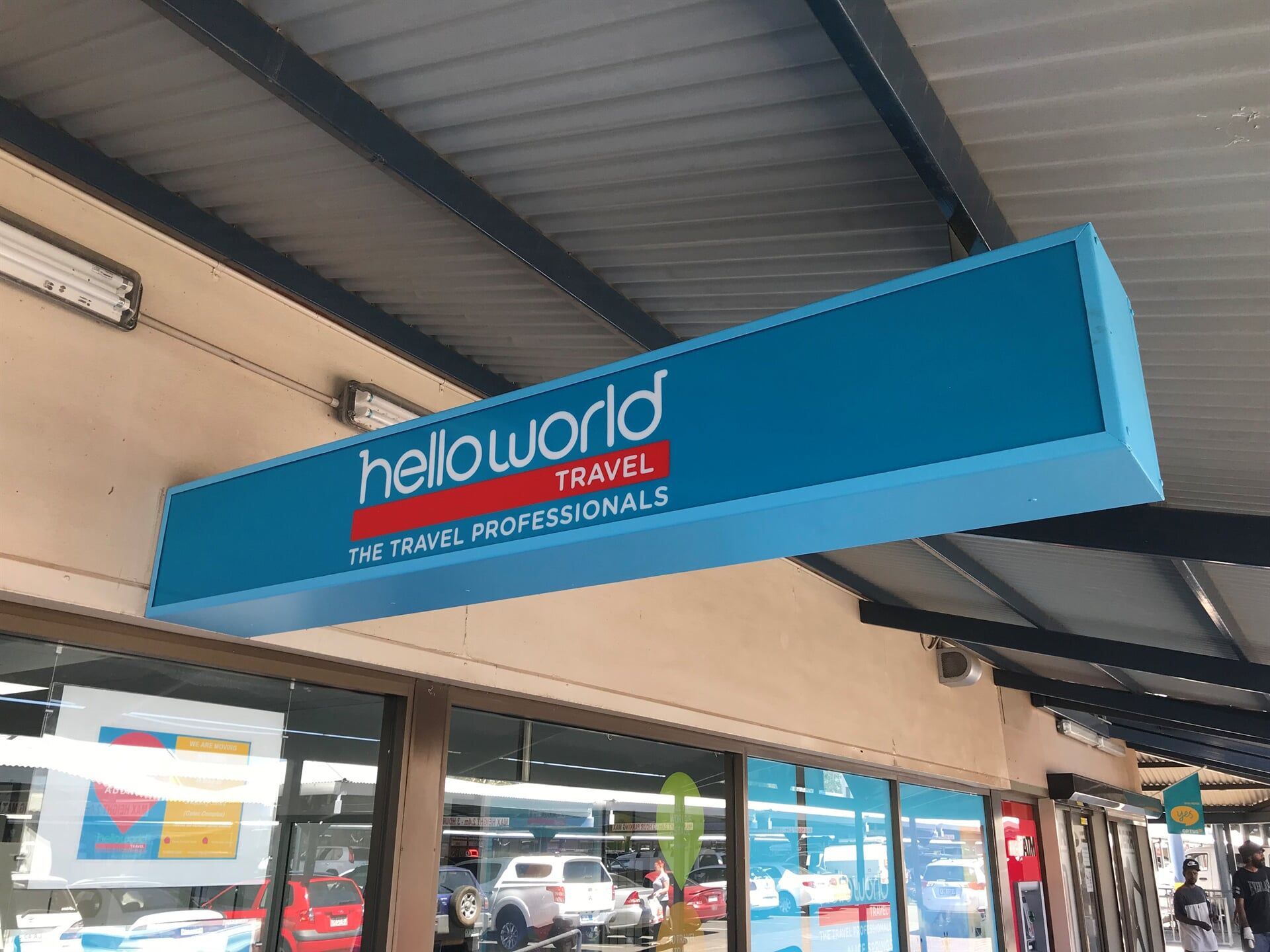 A Helloworld Travel Sign is Hanging From the Ceiling of a Store — Bluey's Signs in Ciccone, NT
