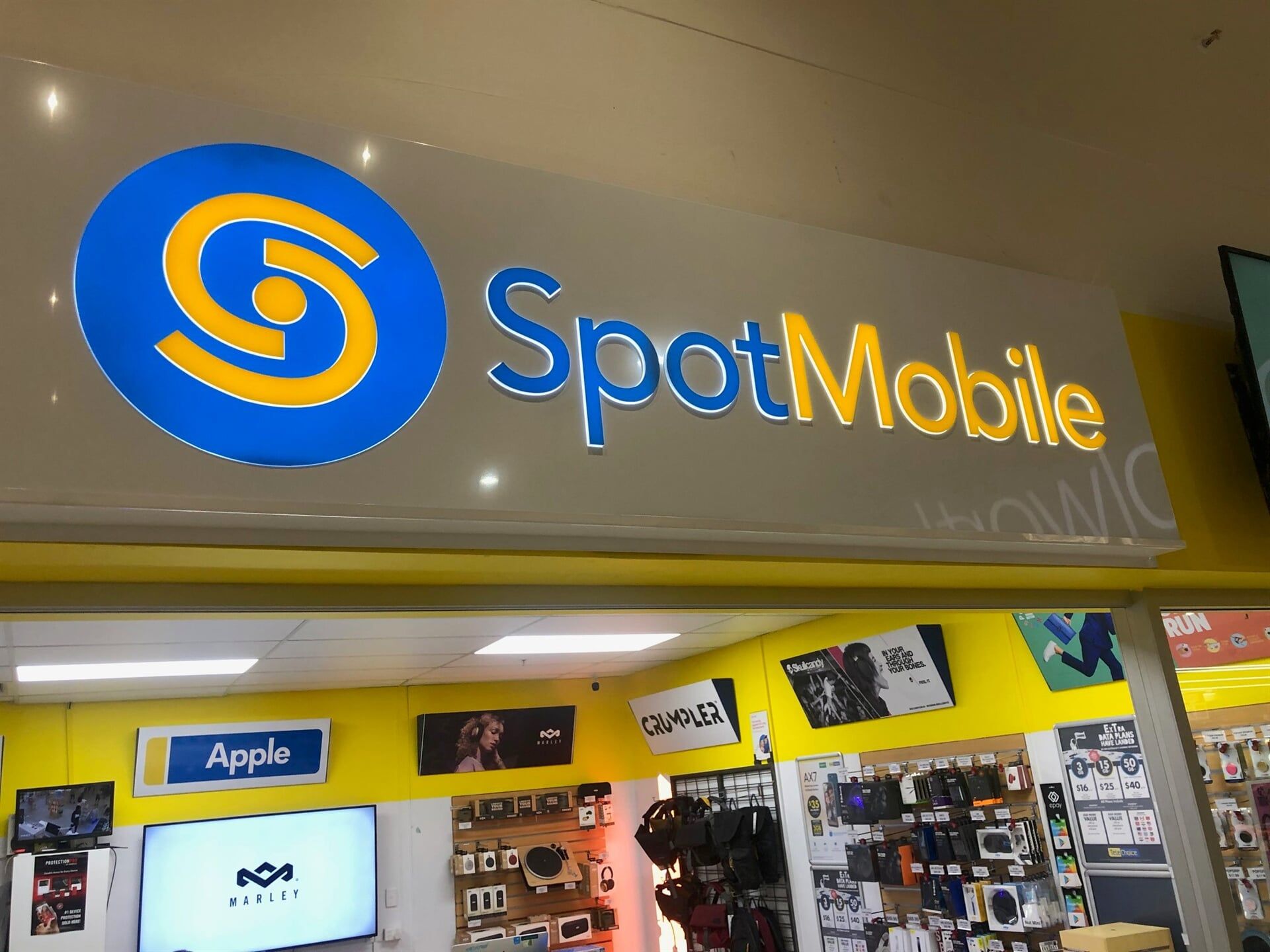 A Store With a Blue and Yellow Sign That Says Spotmobile — Bluey's Signs in Ciccone, NT