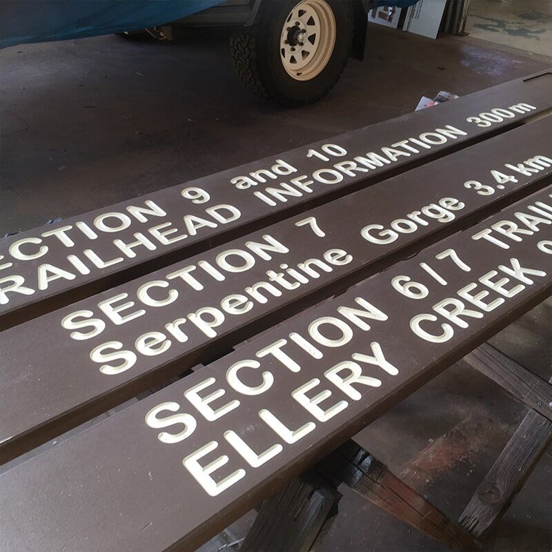 A Wooden Sign That Says Section 9 and 10 Railhead Information — Bluey's Signs in Ciccone, NT