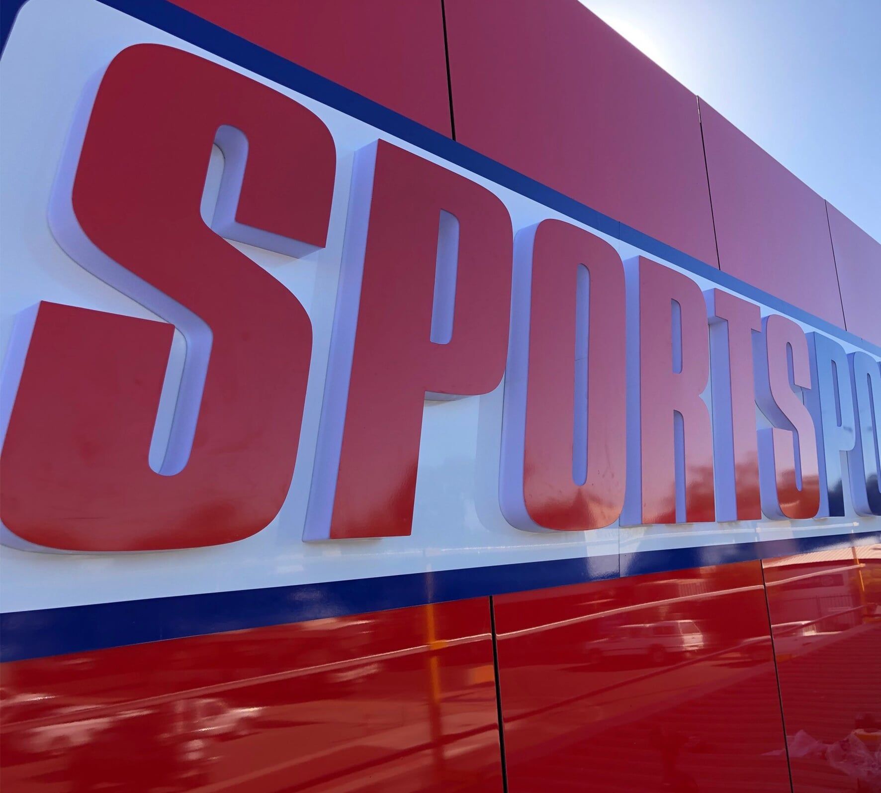 A red and white sign with the word sports on it — Bluey's Signs in Ciccone NT