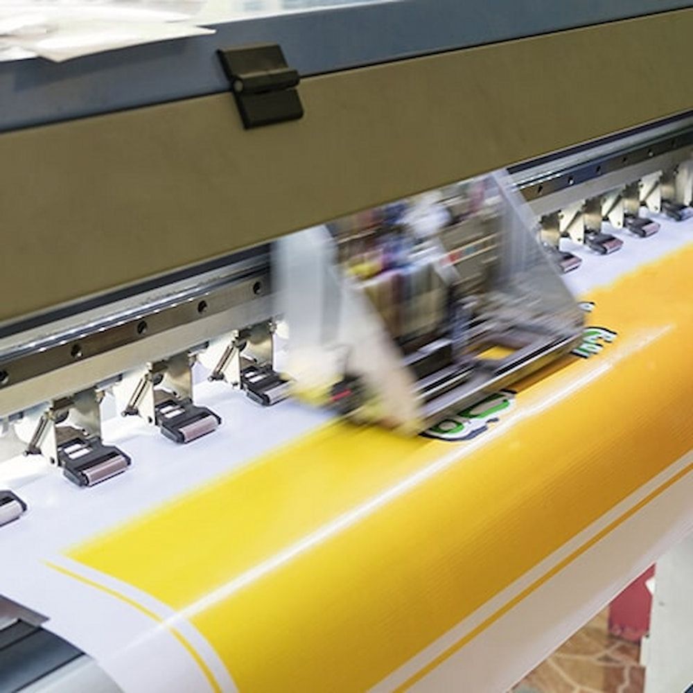 A Printer is Printing a Large Yellow and White Sheet of Paper — Bluey's Signs in Ciccone, NT
