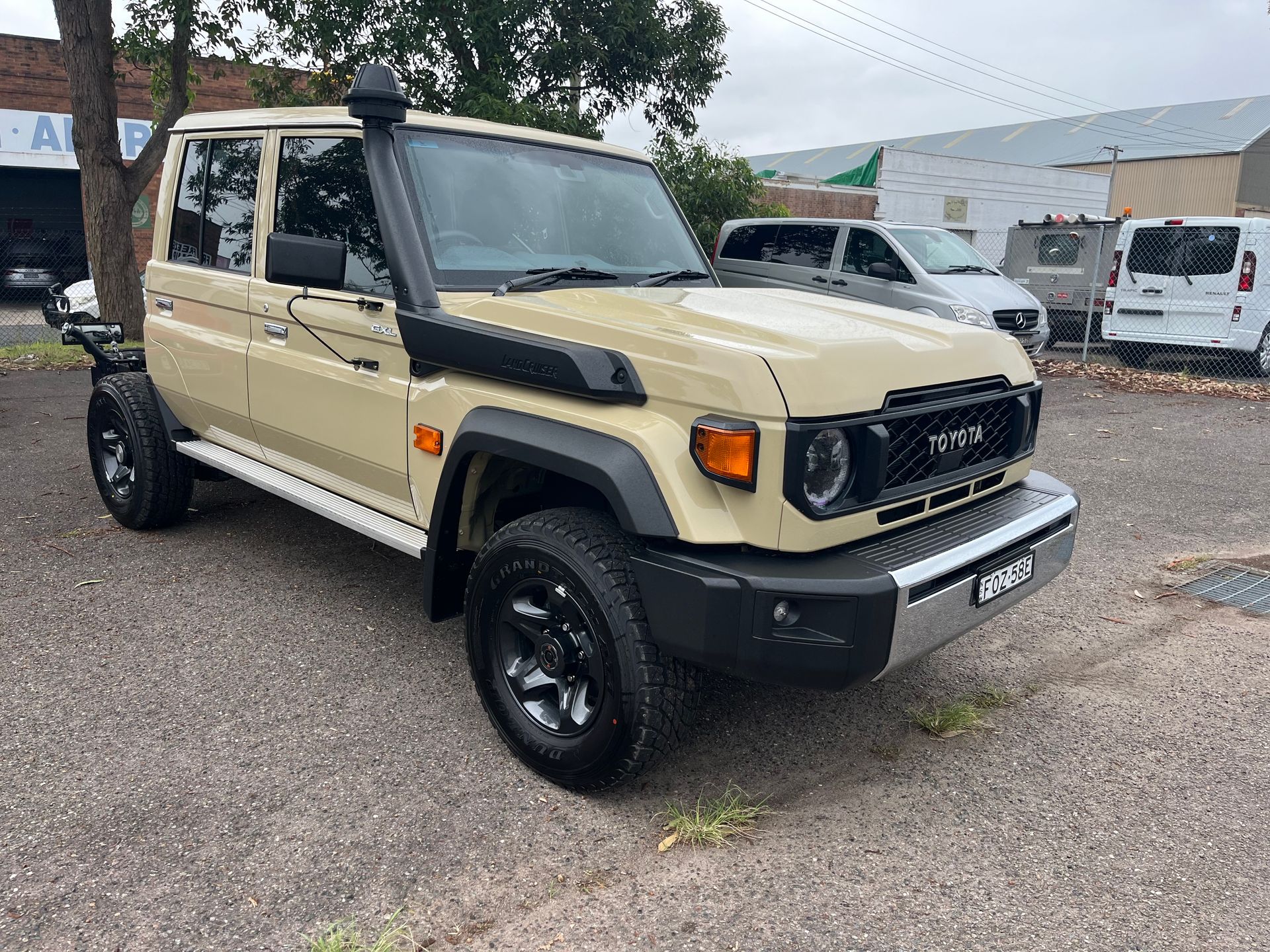 A toyota land cruiser is parked in a gravel lot | Autotek New South Wales