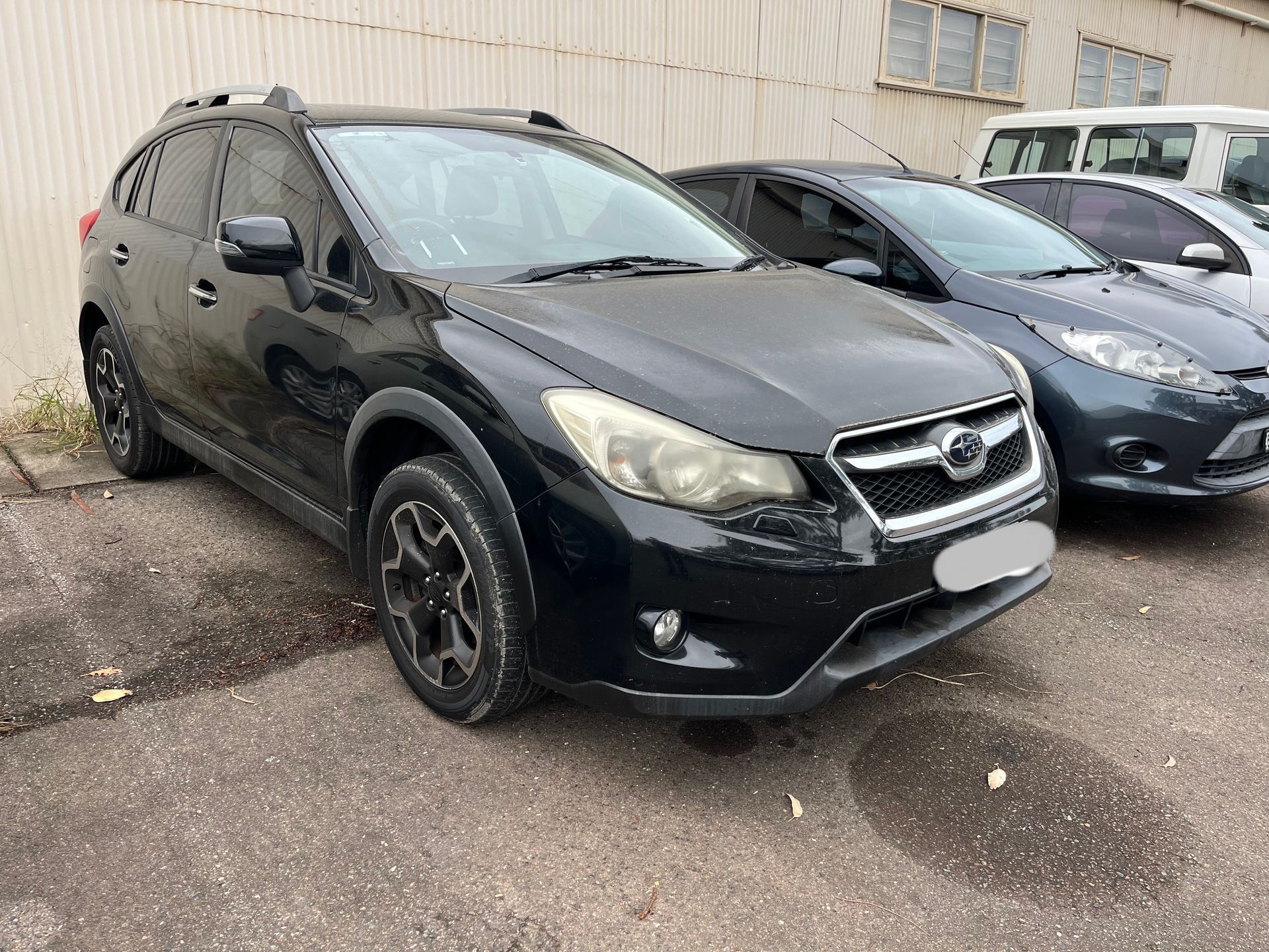 Two black cars are parked next to each other in a parking lot | Autotek New South Wales