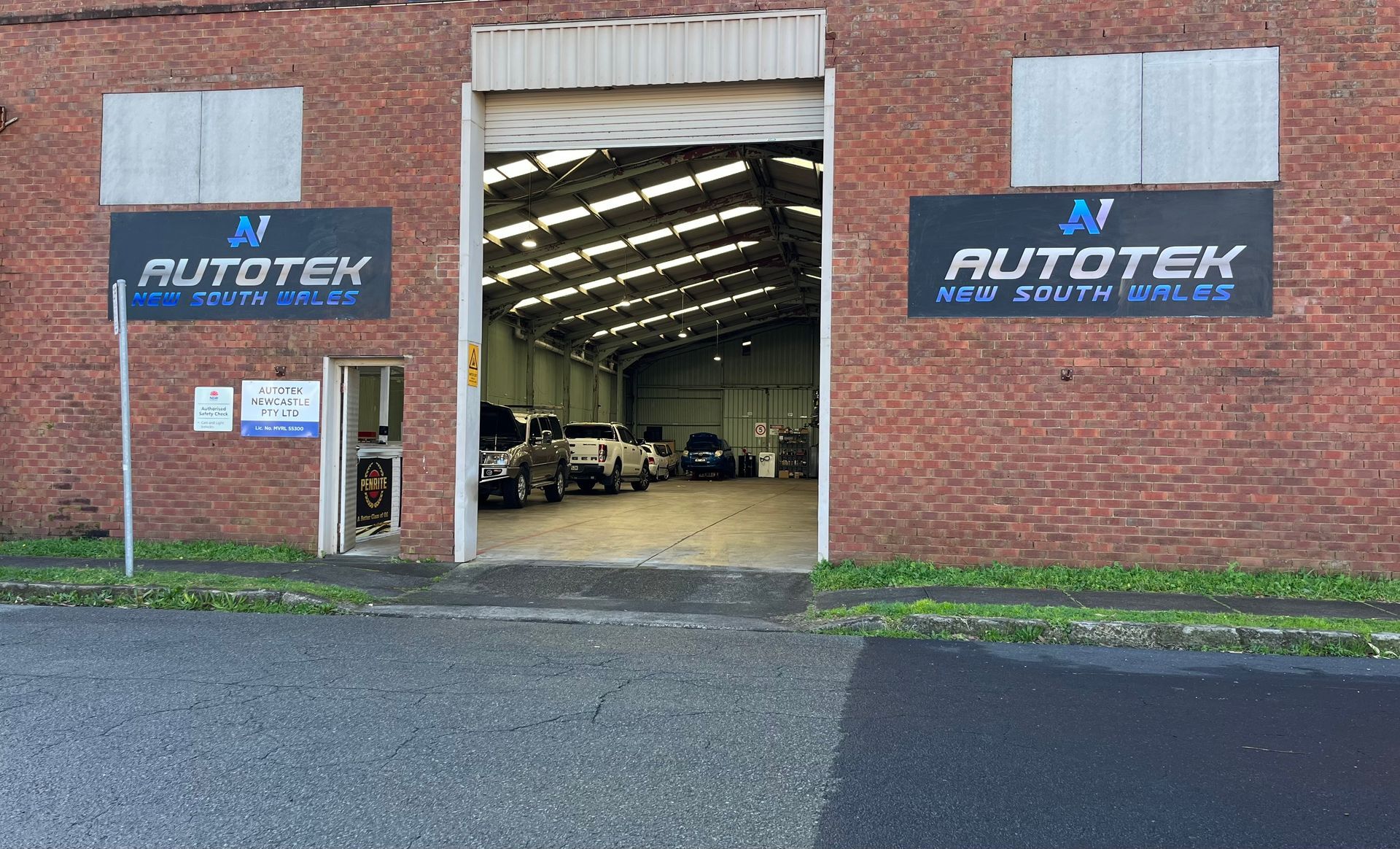 A brick building with a lot of cars parked in front of it | Autotek New South Wales