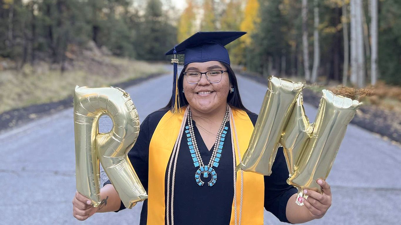 Nicole Pablo in her graduate's cap and gown in Flagstaff.