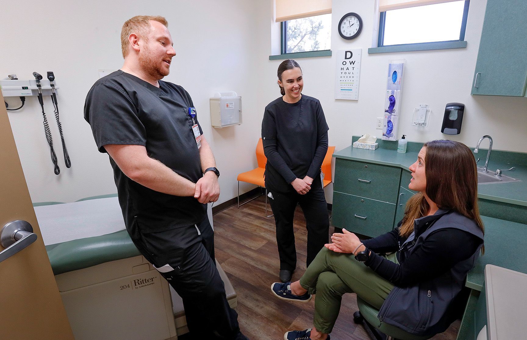 Dr. Sarah Coles (center) consults with residents Dr. Tyler Hanny and Dr. Tasha Harder in an exam room at North Country’s Flagstaff facility.
