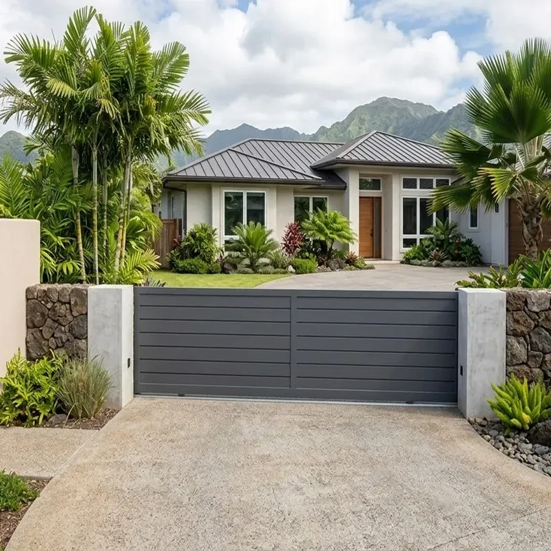 Modern white driveway gate for coastal home in Oahu Hawaii reflecting sunlight with clean minimalist design.