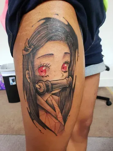 A woman has a tattoo of a girl with red eyes on her leg.