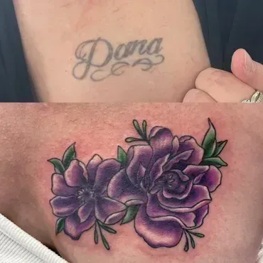 A woman has a tattoo of two purple roses on her arm.