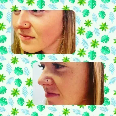 A woman with a nose ring and a nose piercing.