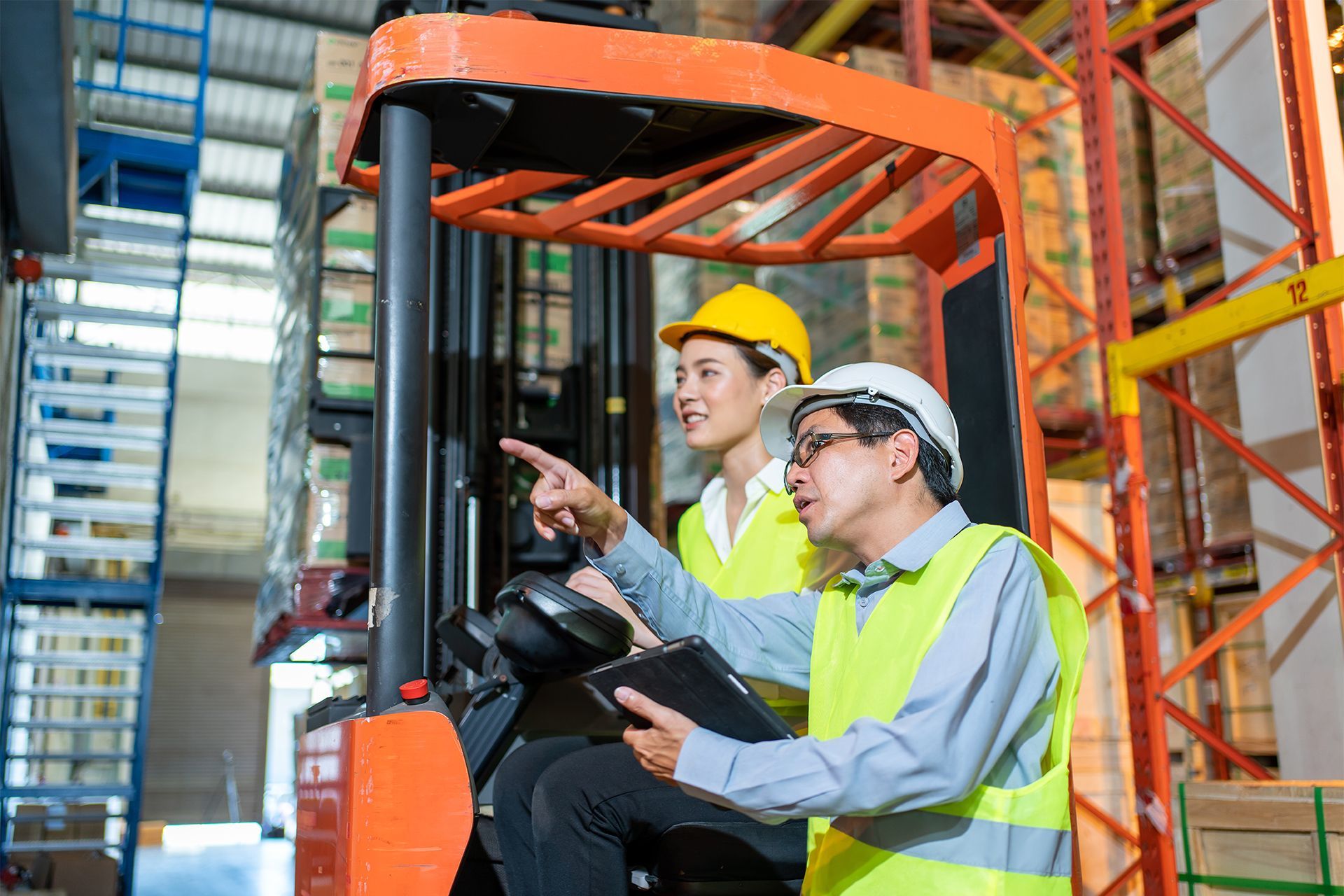 Female Forklift Operator With Trainor