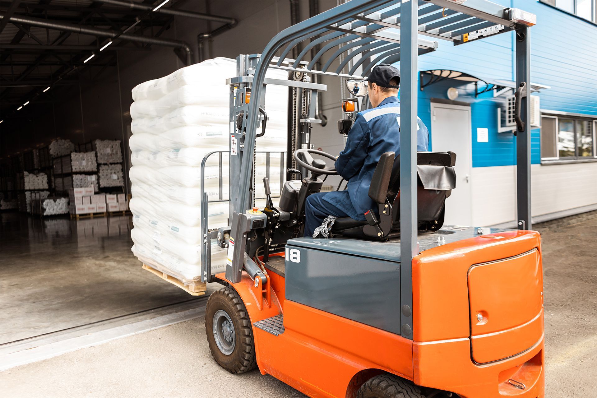 Man Driving a Forklift in a Warehouse