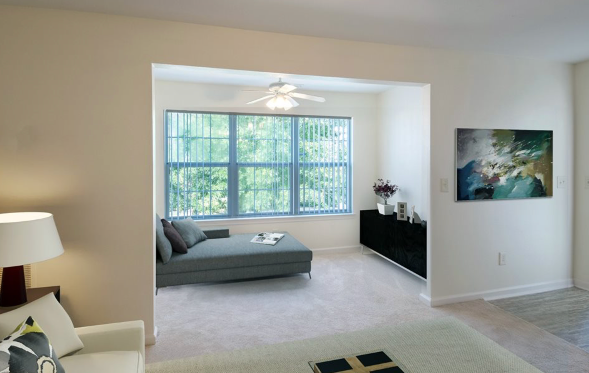 A living room with a couch and a painting on the wall