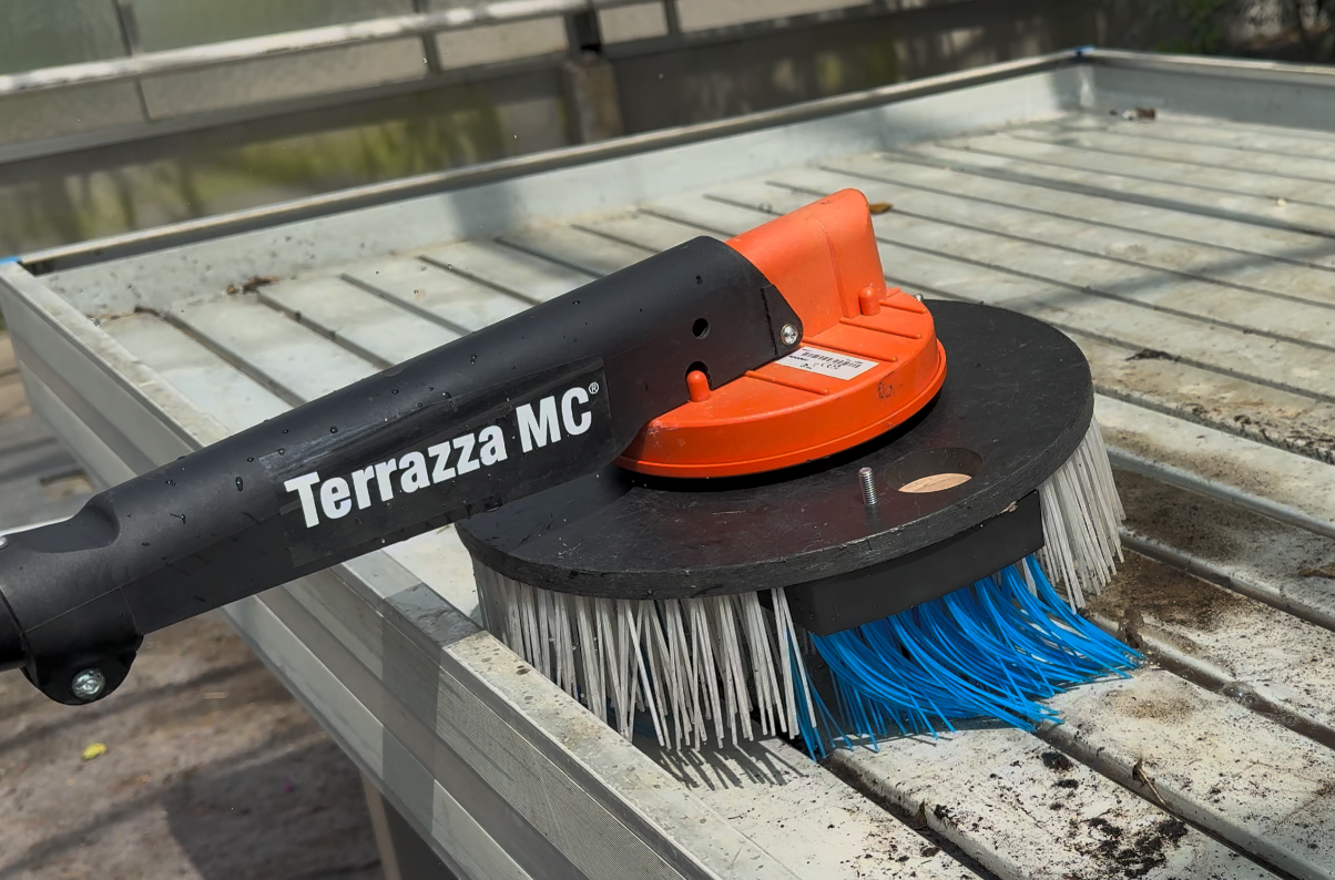 Picture of a patented brush system that is cleaning a nursery table.