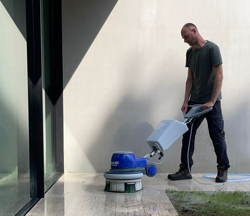 Man working with the Terrazza TMC® Kit on cobble stones.