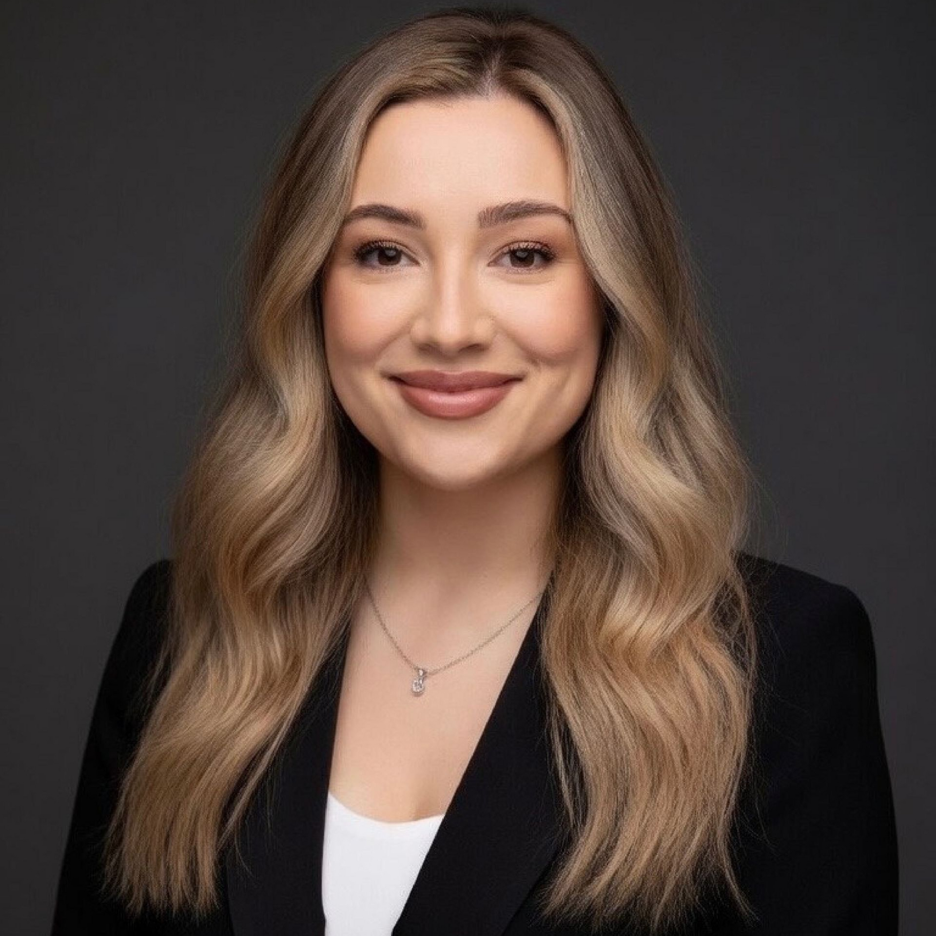 A man in a suit and white shirt is looking at the camera in a circle.