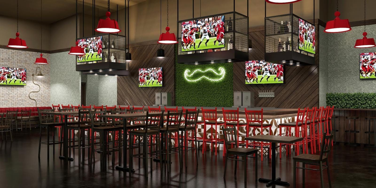 Interior of a sports bar with TV screens, red accents, and a large green mustache.