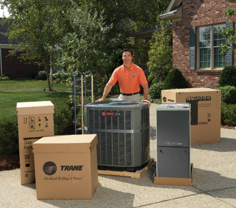Person Standing Next to AC Units — Ogden, UT — Comfort Solutions Person Standing Next to AC Units — Ogden, UT — Comfort Solutions