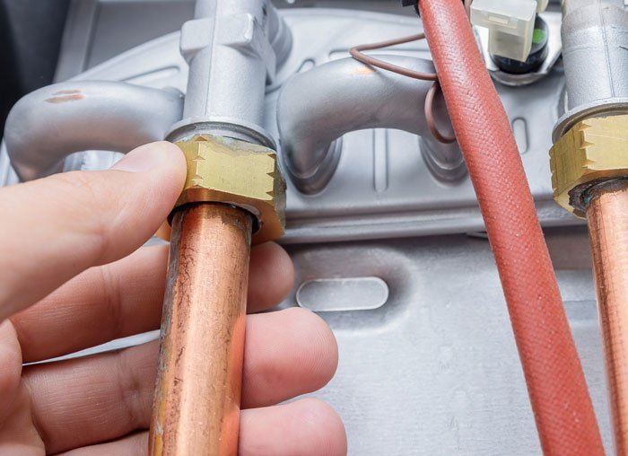 Installing Copper Pipe on Heating Furnace — Ogden, UT — Comfort Solutions