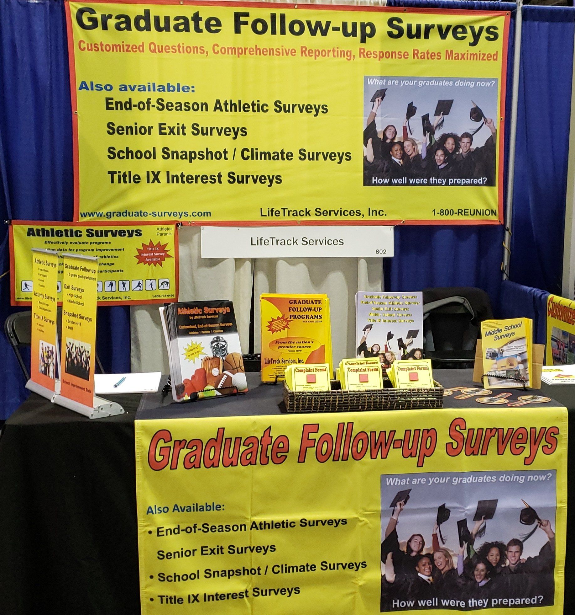 Booth display for graduate follow-up surveys, with brochures and signage about education surveys.