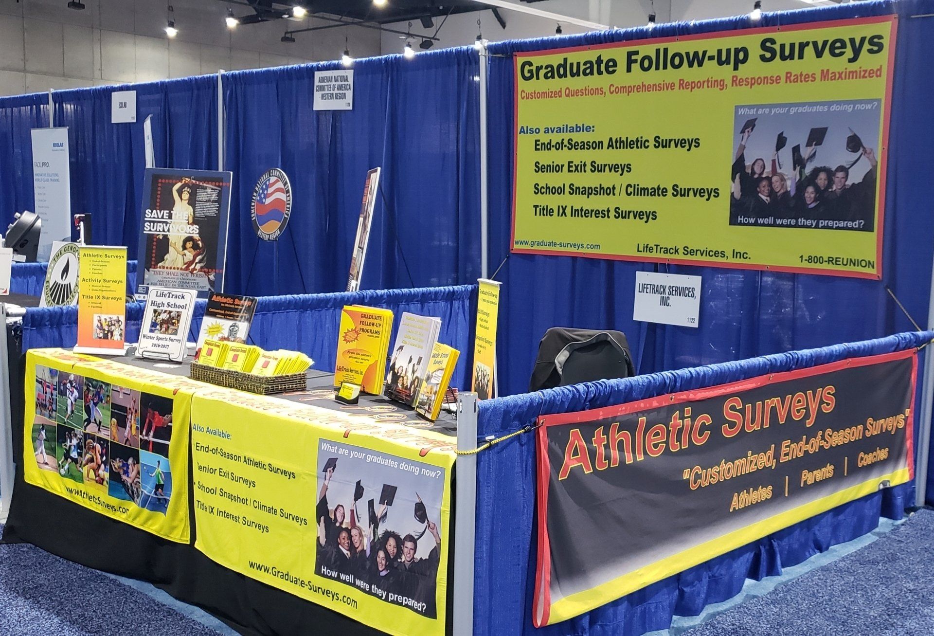 Booth display for athletic surveys, with signage and materials; blue and yellow colors.