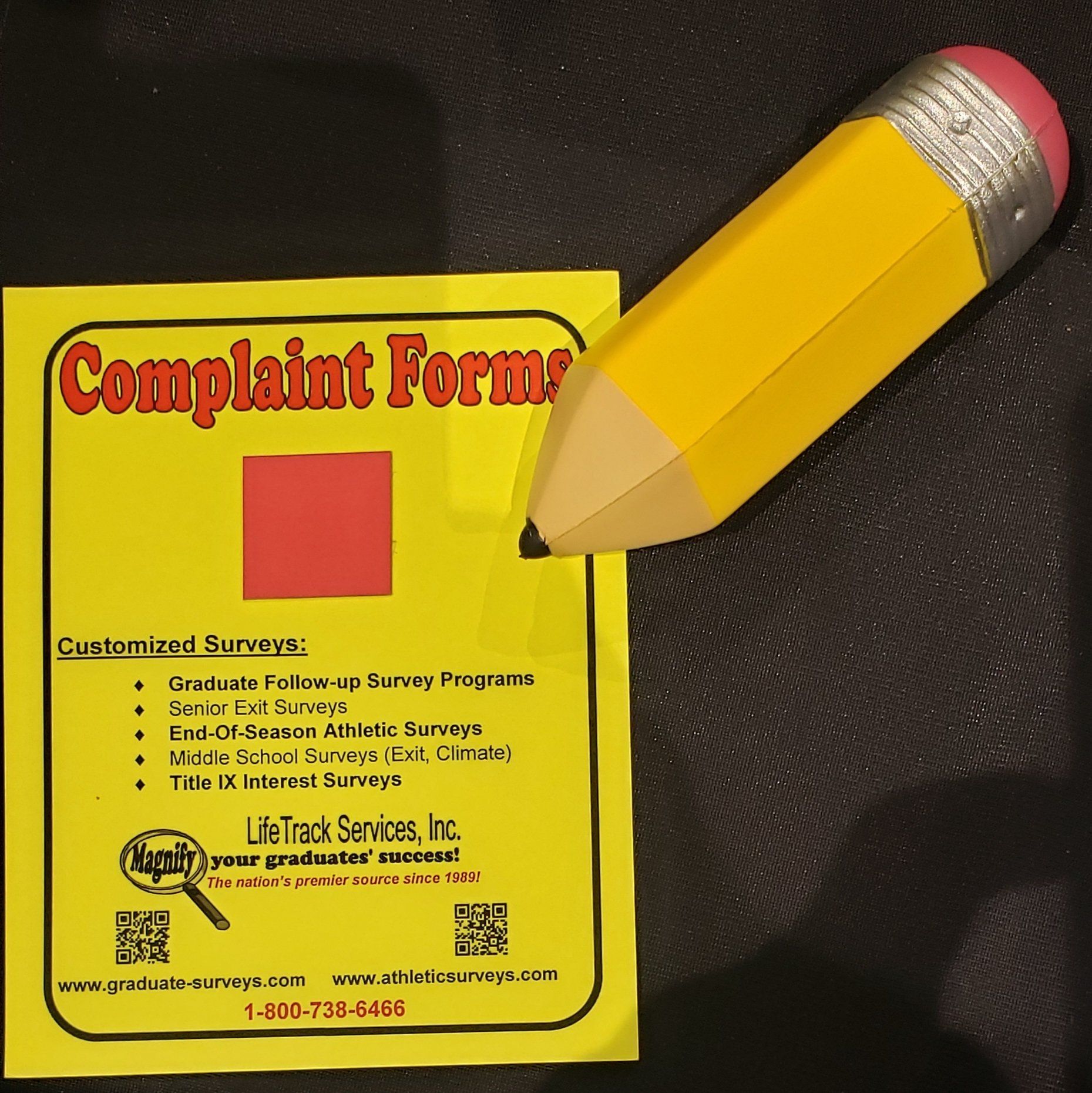 Yellow complaint form with red square, pencil, and