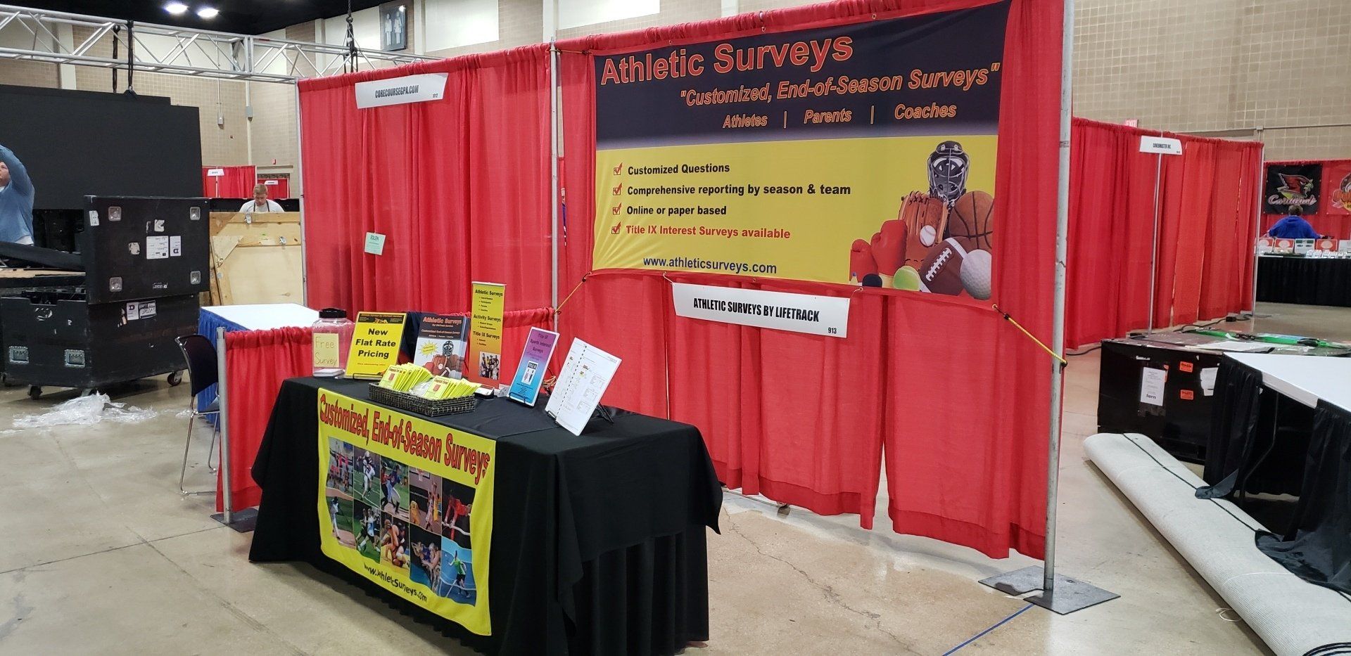 A booth at a convention featuring a banner for