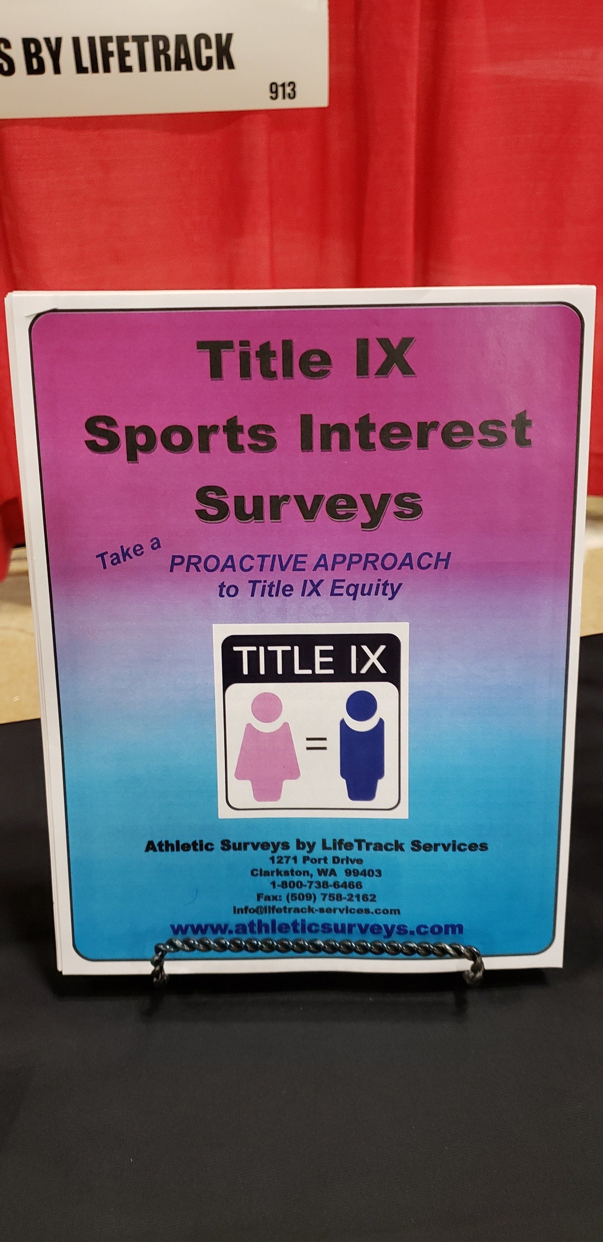 Sign for Title IX Sports Interest Surveys, pink and blue gradient, with equality symbol, and contact info.