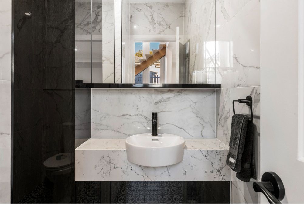 A bathroom with a sink and a mirror. — Peter Betros Homes in Highfields, QLD