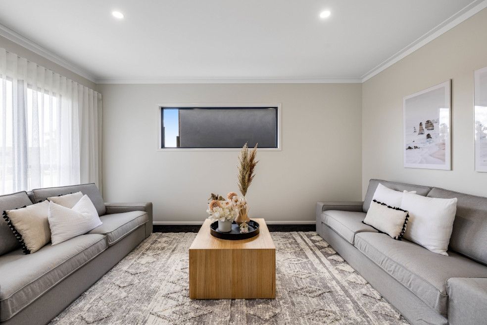 A Living Room with Two Couches and A Coffee Table — Peter Betros Homes in Highfields, QLD