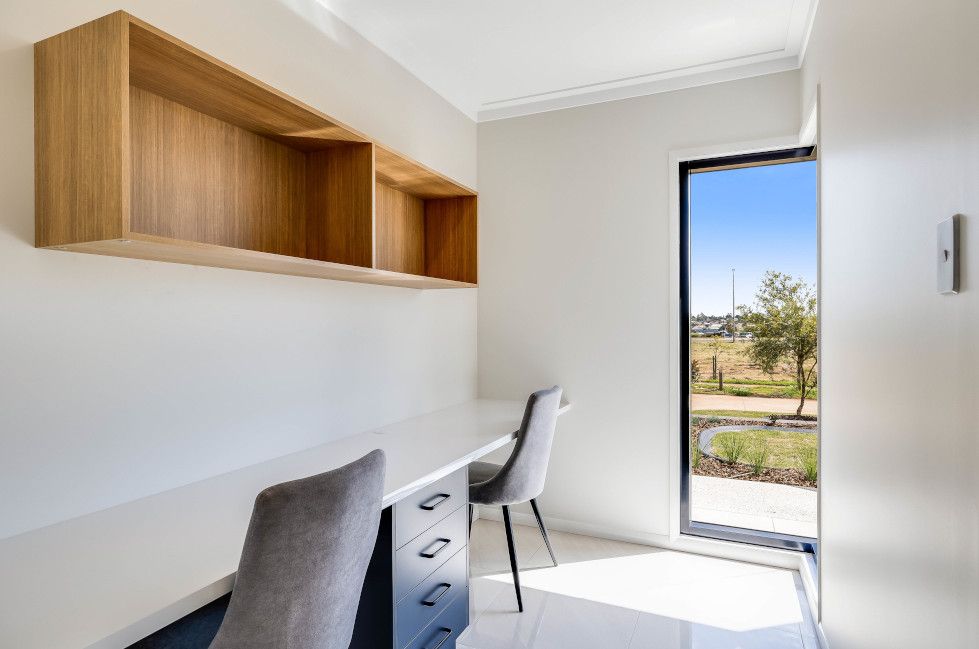 There Is a Desk and Chair in The Room with A Window — Peter Betros Homes in Highfields, QLD