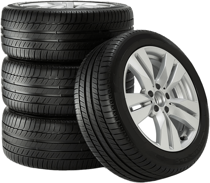 Stack of black car tires with one tire showing a silver alloy wheel