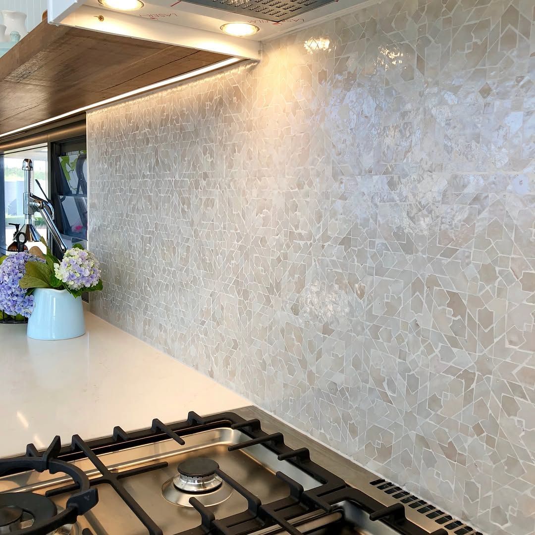A Stove Top Oven is Sitting on Top of a Counter in a Kitchen — Dean Gray Tiling in Gold Coast, QLD