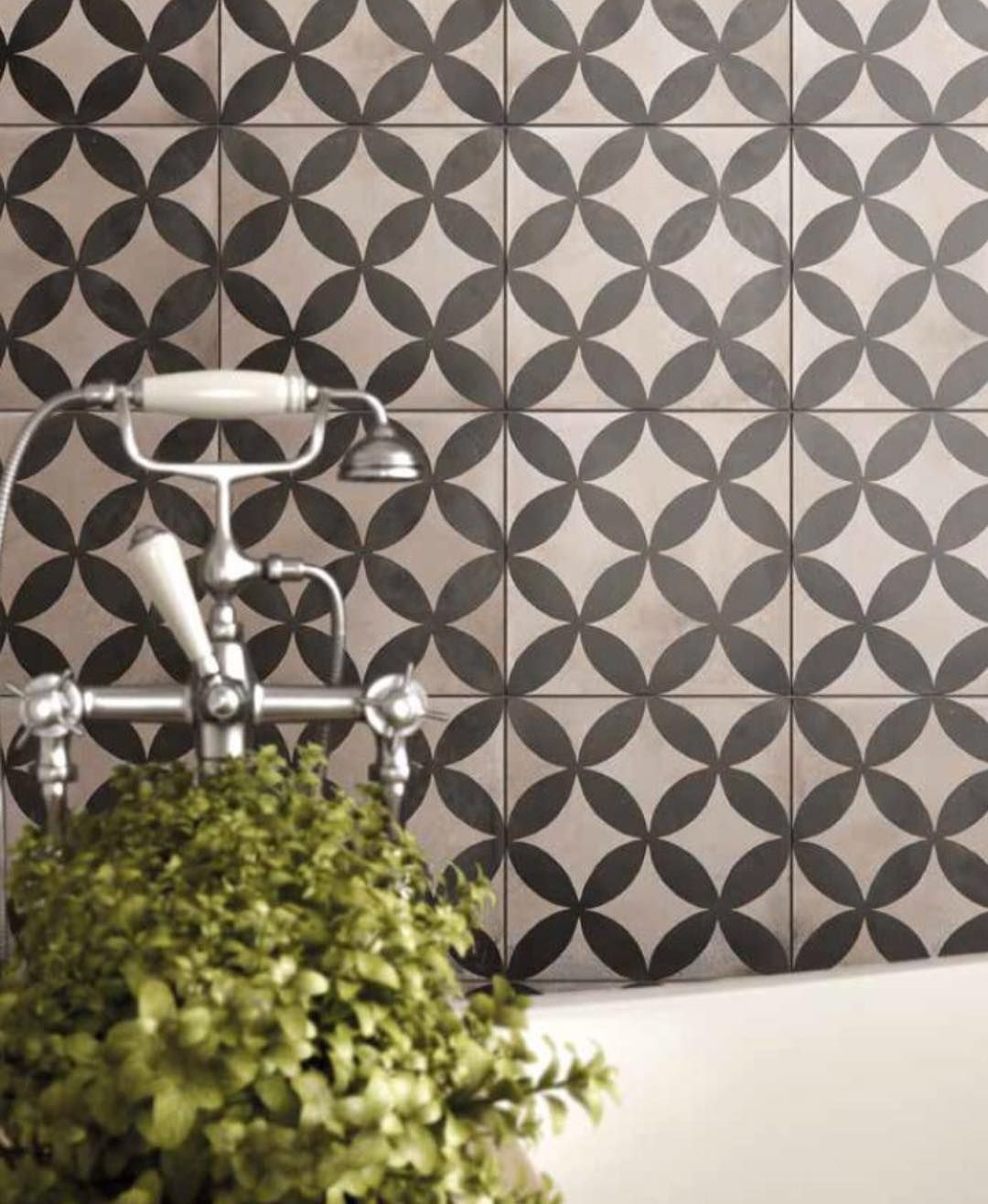 A Bathroom With a Plant and a Bathtub With a Black and White Tile Wall — Dean Gray Tiling in Burleigh, QLD