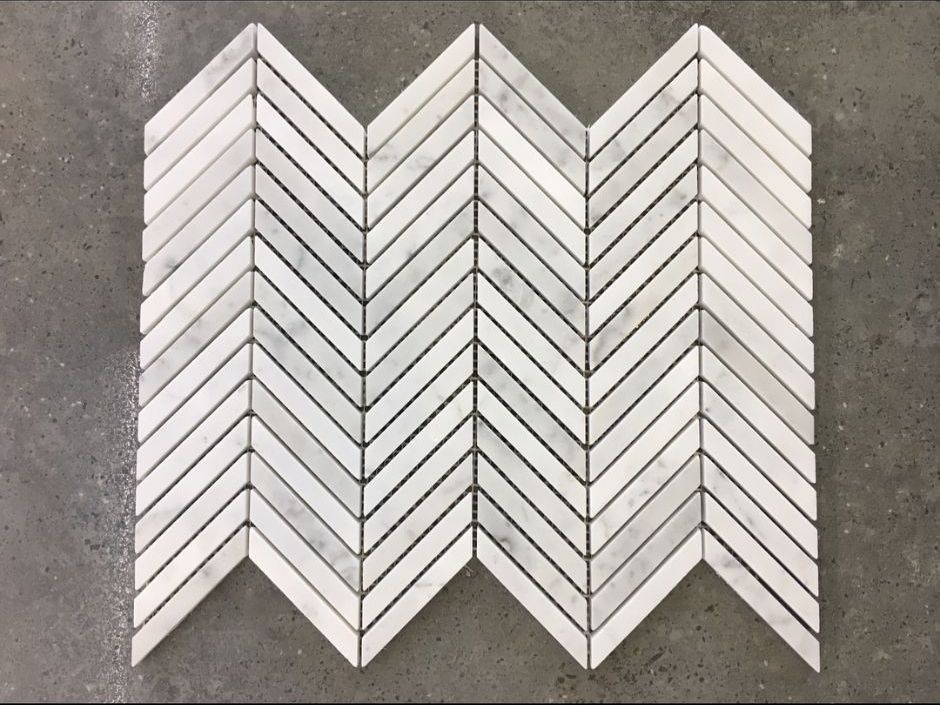 A White Herringbone Mosaic Tile is Sitting on a Concrete Floor — Dean Gray Tiling in Gold Coast, QLD