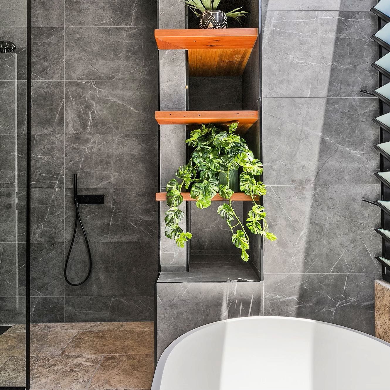 A Bathroom With a Round Mirror and a Sink — Dean Gray Tiling in Hastings Point, NSW