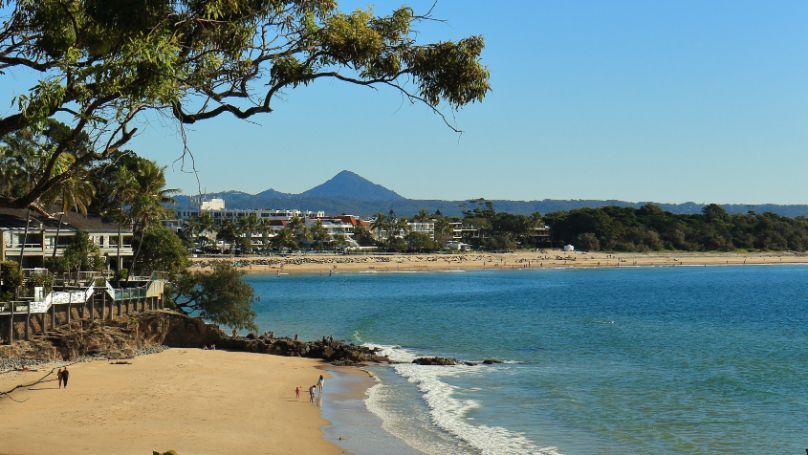 A View of a Beach With a Mountain in the Background — Dean Gray Tiling In Palm Beach, NSW