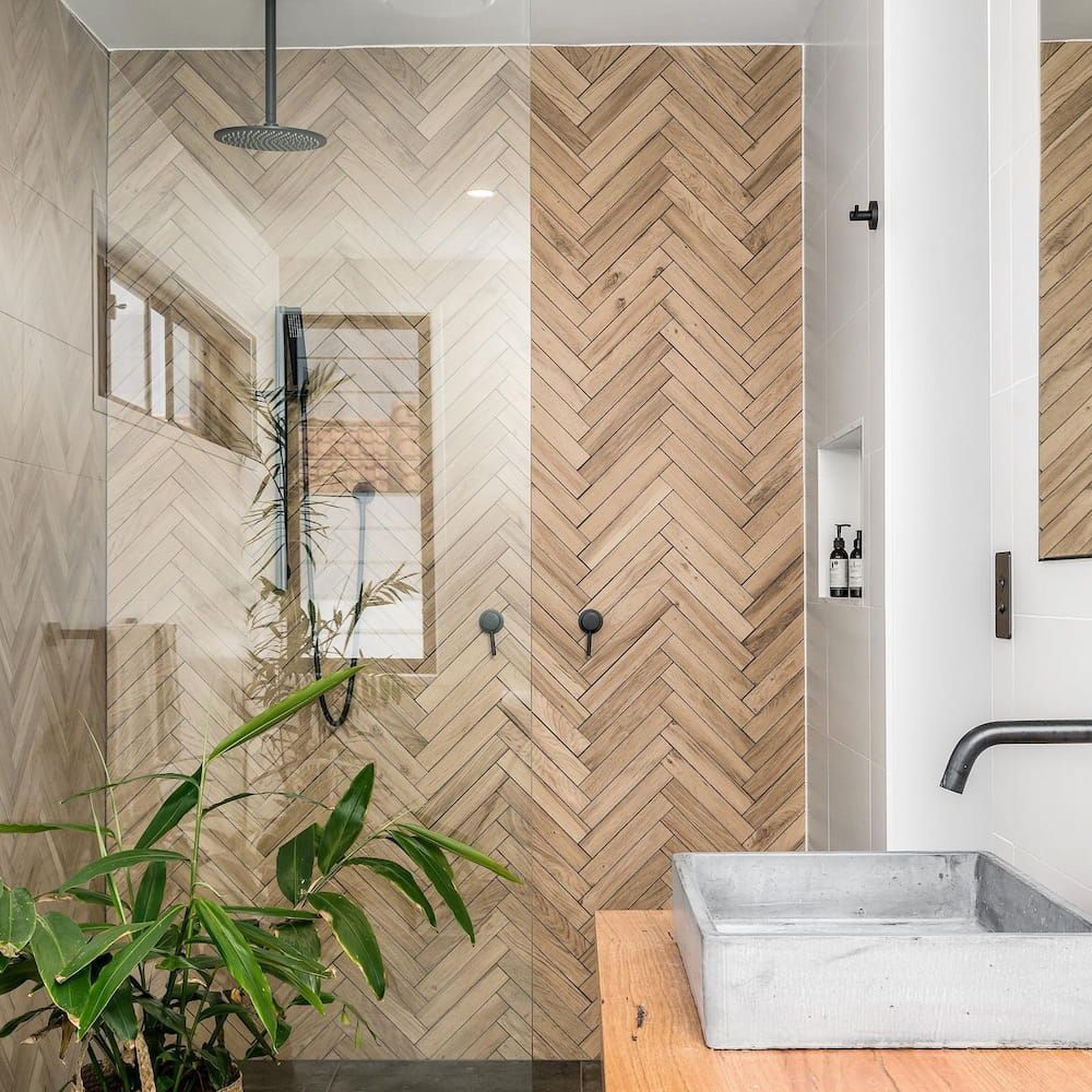 A Bathroom With a Sink and a Shower With a Herringbone Pattern — Dean Gray Tiling in Tweed Heads, NSW