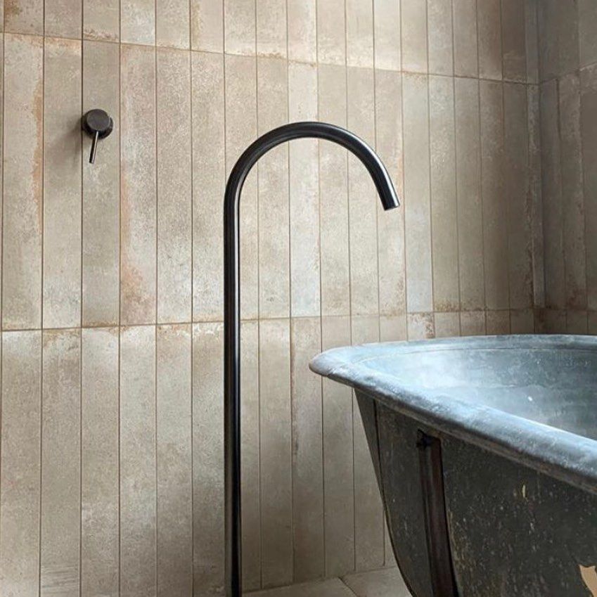 A Bathroom With a Sink, Mirror, and Chevron Tiles — Dean Gray Tiling in Hastings Point, NSW