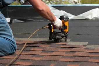 Shingle Roofing Being Nailed