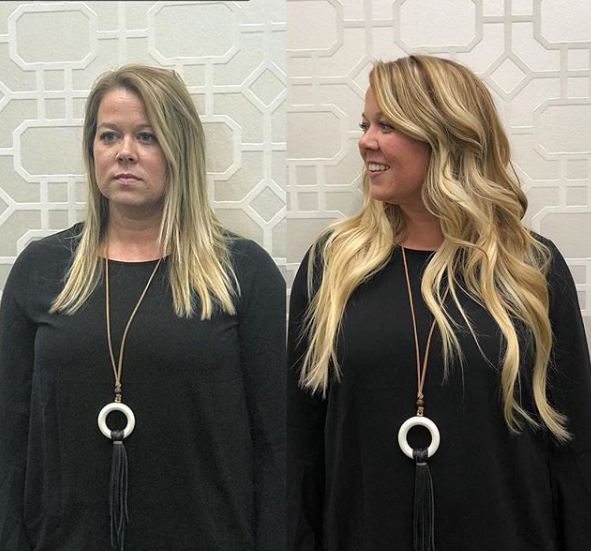 Two women standing next to each other wearing black shirts and necklaces