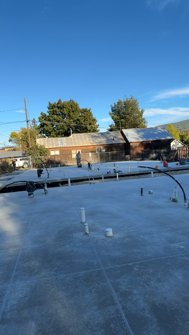 A roof with a lot of pipes on it and a blue sky in the background. Project done by Raise the Bar Construction
