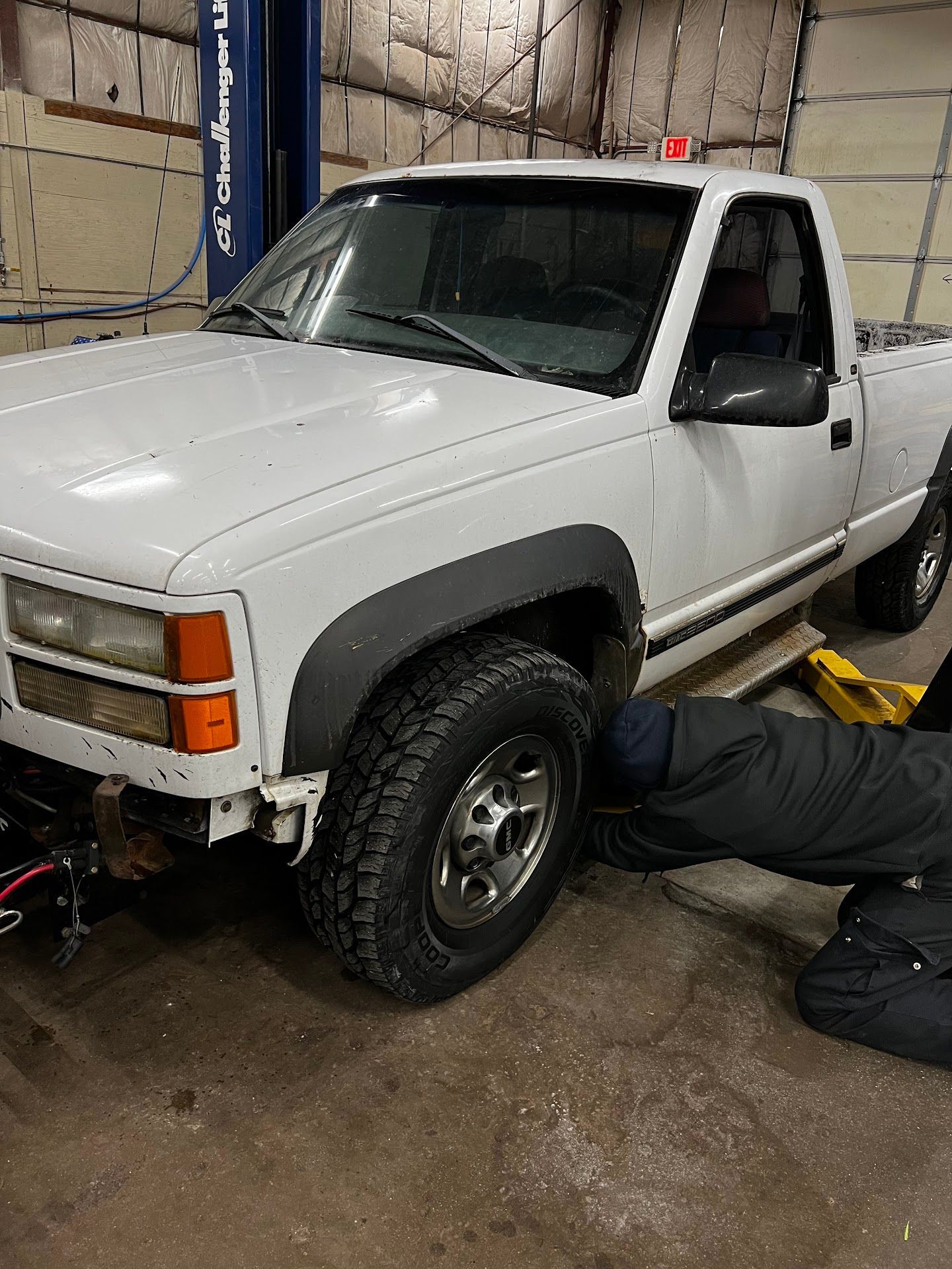 White pickup truck being worked on in a garage | 6 to 6 Auto Service