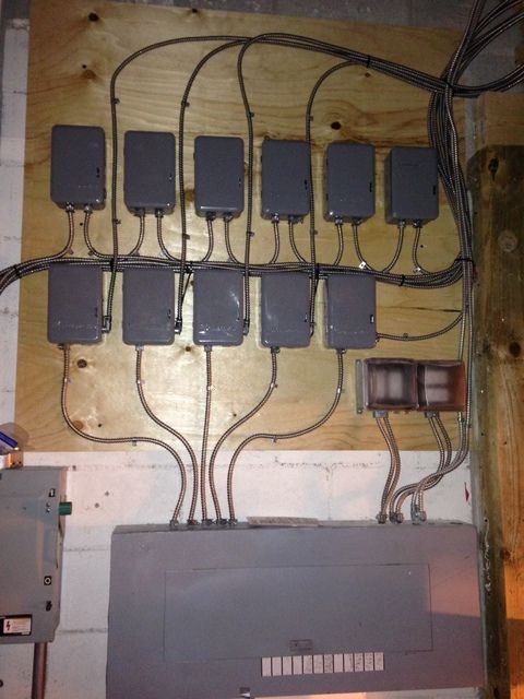 A wall with a bunch of wires coming out of it