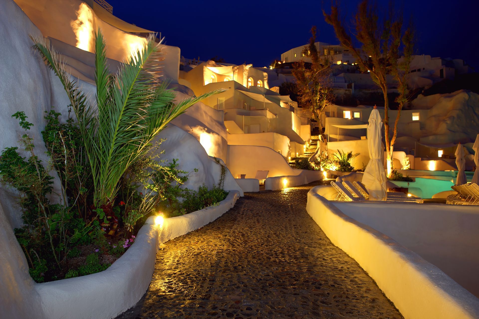 A path leading to a swimming pool at night