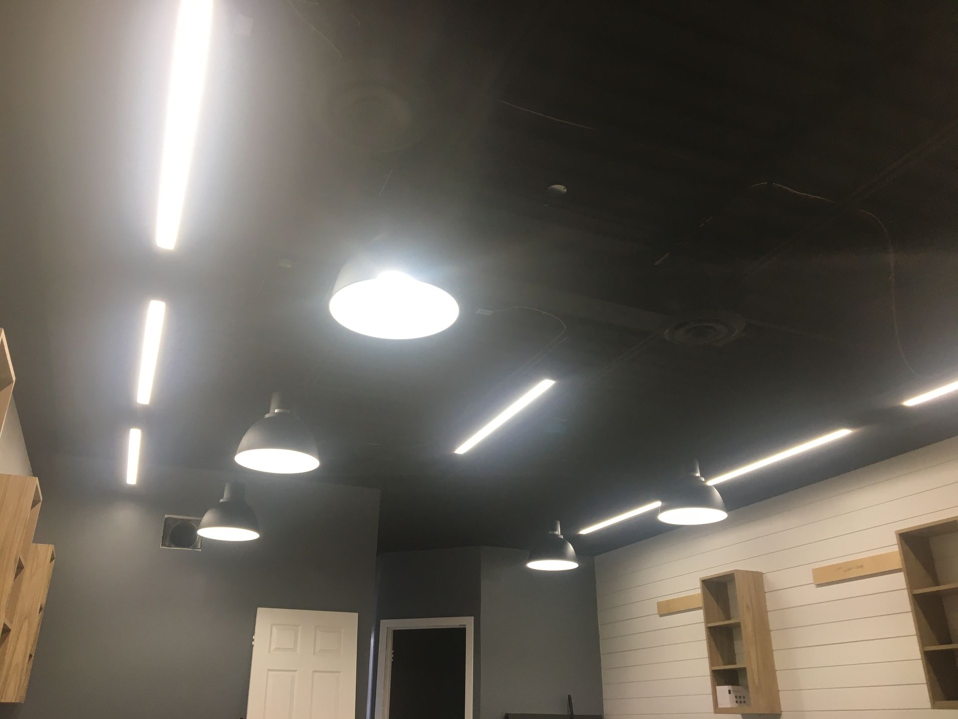 A room with a black ceiling and a lot of lights on it