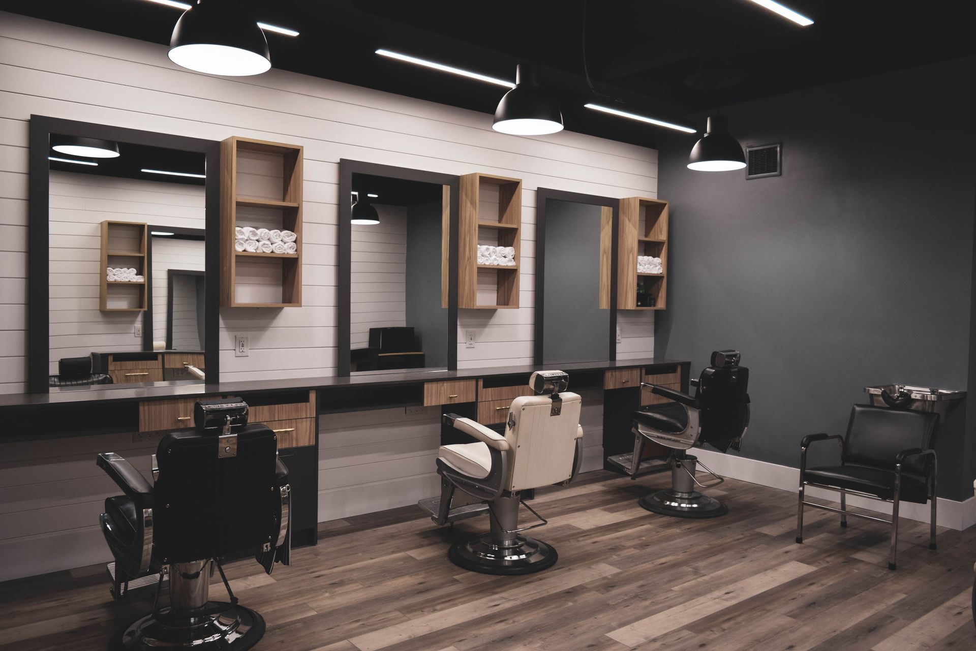 A barber shop with a lot of chairs and mirrors